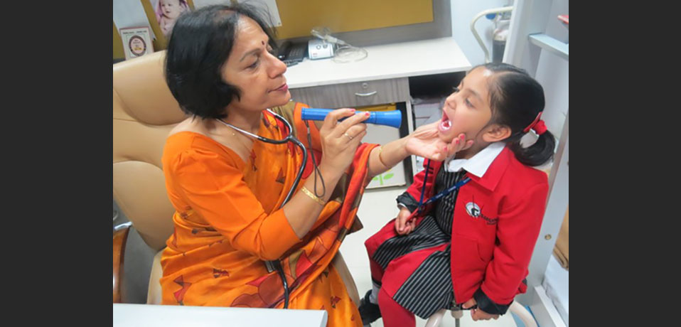 the image shows a doctor is checking up a primary wing student,best school for primary class
