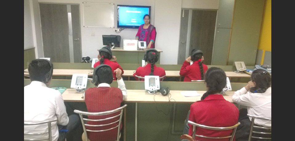 the image shows teacher and students are doing some practical work in language lab,best cbse school in delhi
