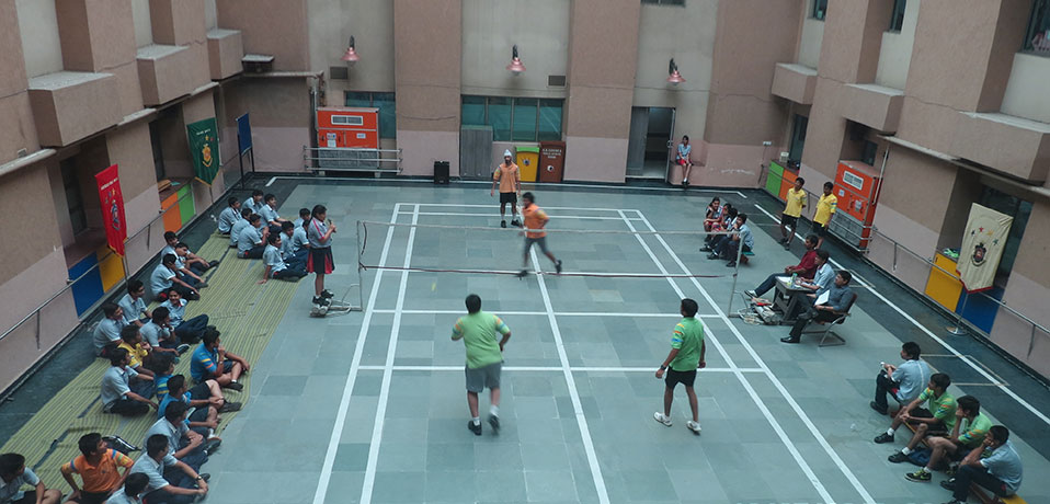 best school for indoor games,students of gd goenka playing badminton in school campus
